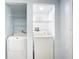 Laundry area featuring a washing machine, dryer and shelving for storage at 8430 Truman St, Englewood, FL 34224