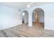 Bright living room boasts fresh paint, ceiling fan, stylish flooring, and arched doorways at 8430 Truman St, Englewood, FL 34224