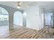Open living room with fresh paint, stylish floors, and easy access to the bathroom and laundry at 8430 Truman St, Englewood, FL 34224