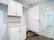 Mud room with storage cabinets, tile flooring, and access to laundry area and outdoors at 8430 Truman St, Englewood, FL 34224