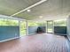Enclosed patio with brick flooring, blue lower walls, and ample natural light at 8430 Truman St, Englewood, FL 34224