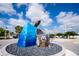 Unique roadside angler fish sculpture sits at the center of a landscaped roundabout under sunny skies at 8430 Truman St, Englewood, FL 34224