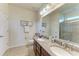 Bathroom featuring double sinks, granite countertops, framed mirrors, and a tiled walk-in shower at 9828 58Th E St, Parrish, FL 34219