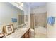 Bathroom with a single sink, granite countertop, framed mirror, and a bathtub with a shower at 9828 58Th E St, Parrish, FL 34219