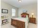 Cozy bedroom with a wood frame bed, and ample natural light from the window at 9828 58Th E St, Parrish, FL 34219
