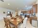 Dining area showcasing the open floor plan, kitchen with granite counters and stainless steel appliances at 9828 58Th E St, Parrish, FL 34219