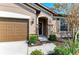 Close-up of a home's front entrance, adorned with stone accents and a charming wreath at 9828 58Th E St, Parrish, FL 34219