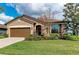 Inviting home exterior showcasing the lush landscaping and well-maintained lawn at 9828 58Th E St, Parrish, FL 34219