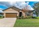 Charming single-story home with a well-manicured lawn, colorful flowerbeds, and a two-car garage at 9828 58Th E St, Parrish, FL 34219