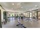 Spacious gym with ample natural light, offering a range of exercise equipment for diverse fitness needs at 9828 58Th E St, Parrish, FL 34219