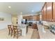 Spacious kitchen showcasing a granite island with seating, stainless steel appliances, and ample cabinet space at 9828 58Th E St, Parrish, FL 34219