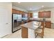 Well-lit kitchen featuring stainless steel appliances, granite counters, and a central island with bar seating at 9828 58Th E St, Parrish, FL 34219