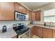 A well-equipped kitchen featuring stainless steel appliances, granite countertops, and ample cabinet storage at 9828 58Th E St, Parrish, FL 34219