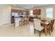 Open-concept kitchen and dining area with stainless steel appliances, granite counters, and tile flooring at 9828 58Th E St, Parrish, FL 34219
