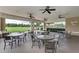 Inviting outdoor patio with comfortable seating and ceiling fans, perfect for dining and social gatherings at 9828 58Th E St, Parrish, FL 34219