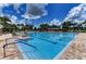 Inviting community swimming pool with lounge chairs and a sunshade for relaxation and recreation at 9828 58Th E St, Parrish, FL 34219