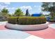 A statue is displayed on a concrete area with seating and landscaping adding to the community's charm at 12046 Forest Park Cir, Bradenton, FL 34211