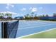 A sunny blue and green tennis court offers a recreational amenity for residents at 12046 Forest Park Cir, Bradenton, FL 34211