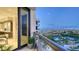Scenic balcony view showcases the city, bay, and lush greenery with blue skies in the background at 1241 Gulf Of Mexico Dr # 1005, Longboat Key, FL 34228