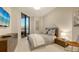 A serene bedroom with a modern bed, stylish furnishings, and balcony access offers a relaxing retreat at 1241 Gulf Of Mexico Dr # 1005, Longboat Key, FL 34228