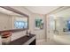 Elegant foyer with dark wood console table, contemporary artwork, tile floor and view to the living area at 1241 Gulf Of Mexico Dr # 1005, Longboat Key, FL 34228