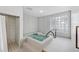 Indoor hot tub area with tiled walls, shower, glass block window, and steps for easy access at 1241 Gulf Of Mexico Dr # 1005, Longboat Key, FL 34228