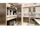 Gourmet kitchen featuring stainless steel appliances and tile backsplash at 1241 Gulf Of Mexico Dr # 1005, Longboat Key, FL 34228