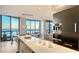 Modern open concept kitchen flows into living space with ocean views at 1241 Gulf Of Mexico Dr # 1005, Longboat Key, FL 34228