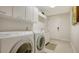 Bright laundry room featuring a modern washer and dryer and ample cabinet space at 1241 Gulf Of Mexico Dr # 1005, Longboat Key, FL 34228