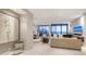 Open concept living area with floor-to-ceiling windows offering stunning ocean views, modern decor, and tile floors at 1241 Gulf Of Mexico Dr # 1005, Longboat Key, FL 34228