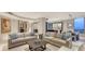 Open living space with large windows, modern sofas, and a view to a dining area and contemporary kitchen at 1241 Gulf Of Mexico Dr # 1005, Longboat Key, FL 34228