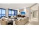 An elegant living room features floor-to-ceiling windows with ocean views and stylish furnishings at 1241 Gulf Of Mexico Dr # 1005, Longboat Key, FL 34228