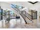 A stunning lobby with staircase, marble floors, and views of the outdoor patio at 1241 Gulf Of Mexico Dr # 1005, Longboat Key, FL 34228