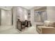 A cozy office nook with a contemporary dark wood desk, chair, and stylish decor creates an inspiring workspace at 1241 Gulf Of Mexico Dr # 1005, Longboat Key, FL 34228