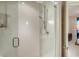 Modern bathroom shower featuring glass doors, sleek fixtures, and a built-in shelf at 1241 Gulf Of Mexico Dr # 1005, Longboat Key, FL 34228