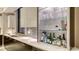 Entertainer's wet bar features glass shelving and counter with sink at 1241 Gulf Of Mexico Dr # 1005, Longboat Key, FL 34228