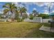 Large backyard showing mature trees, a utility shed, and outdoor seating area for entertaining at 1409 2Nd E Ave, Bradenton, FL 34208