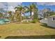 Expansive backyard featuring mature trees, a well-kept lawn, and a shed, providing ample outdoor space at 1409 2Nd E Ave, Bradenton, FL 34208