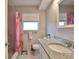 Renovated bathroom features granite countertop vanity, and a shower with stylish tiling and a window at 1409 2Nd E Ave, Bradenton, FL 34208