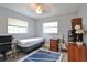Cozy bedroom features natural light from two windows, complemented by a ceiling fan and neutral tones at 1409 2Nd E Ave, Bradenton, FL 34208