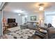 Cozy living area with a sectional sofa, patterned rug, and a large TV at 1409 2Nd E Ave, Bradenton, FL 34208