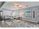 Bright living room with a gray sofa, large windows, and hardwood floors at 1409 2Nd E Ave, Bradenton, FL 34208