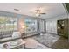Inviting living room with gray sofa, large windows, and an area rug at 1409 2Nd E Ave, Bradenton, FL 34208