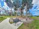 Scenic park view featuring a bench, palm trees, and a glimpse of nearby building in a serene waterfront setting at 1409 2Nd E Ave, Bradenton, FL 34208