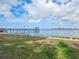 Picturesque waterfront view with a pier extending into the calm water, under a beautiful blue sky with fluffy clouds at 1409 2Nd E Ave, Bradenton, FL 34208