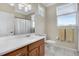 Bathroom with a wood vanity, white counter top, and tile floors at 14205 Nighthawk Ter, Lakewood Ranch, FL 34202
