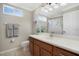 Bathroom featuring wood cabinets, a white countertop, and a framed mirror at 14205 Nighthawk Ter, Lakewood Ranch, FL 34202