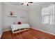 Bright bedroom with hardwood floors, ceiling fan, window, and storage under the bed at 14205 Nighthawk Ter, Lakewood Ranch, FL 34202