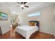 Cozy bedroom with hardwood floors, a sitting area near the window and a comfortable queen-size bed at 14205 Nighthawk Ter, Lakewood Ranch, FL 34202