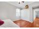 Bedroom featuring hardwood floors, closet, ceiling fan, and bright window at 14205 Nighthawk Ter, Lakewood Ranch, FL 34202